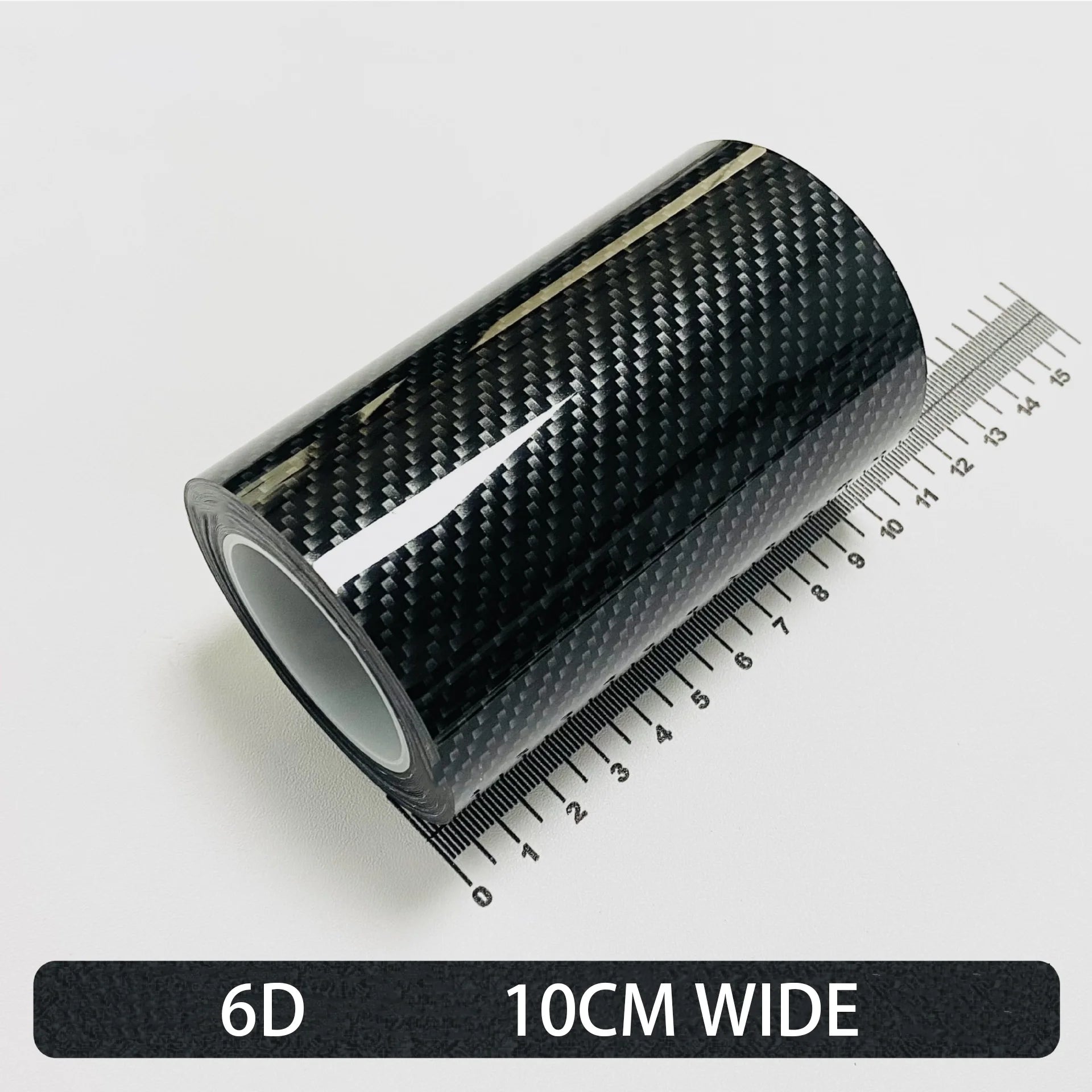Roll of High-Gloss 6D carbon fibre wrap tape, 10cm wide, shown on a white background with a ruler for scale.