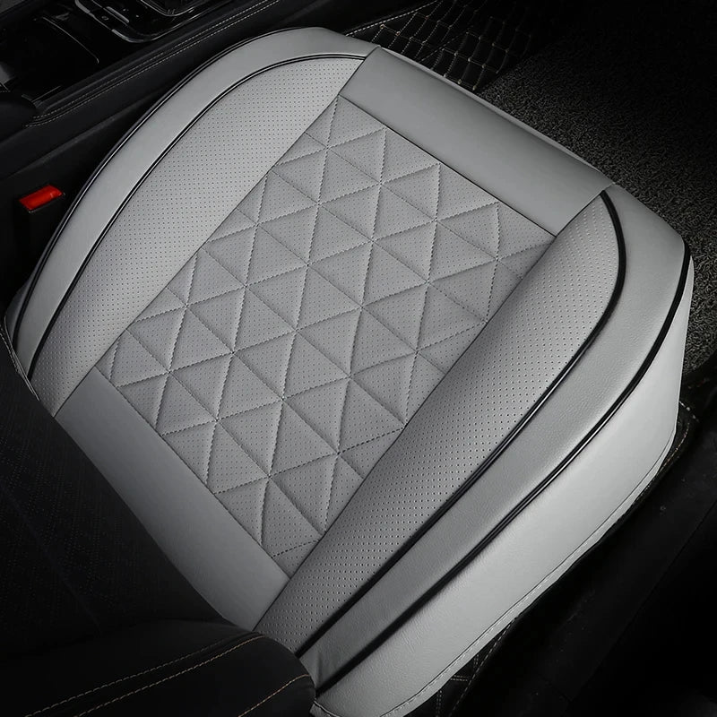 Front Seat Cushion Cover in grey fitted to a car seat, close-up angled view