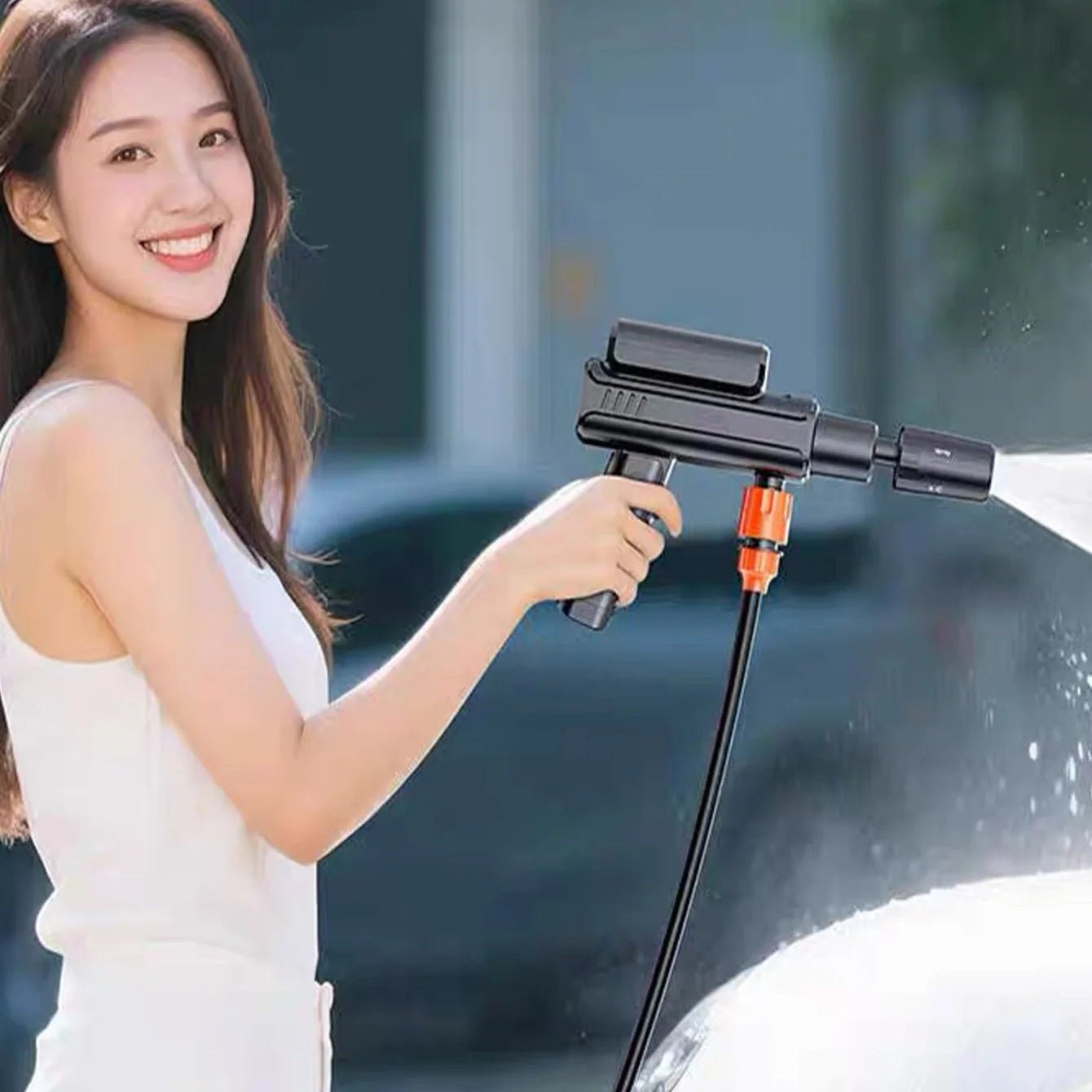 Woman using a Cordless Car Pressure Washer to rinse her car in a driveway, demonstrating easy one-handed operation.