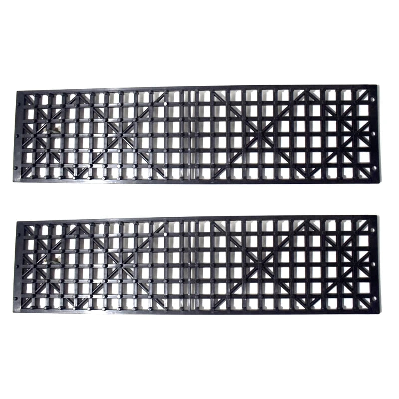 Two black emergency tyre traction mats with grid traction pattern on white background