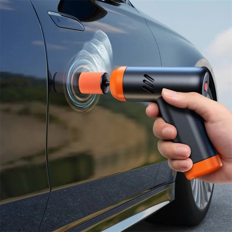 Cordless Mini Polisher being used by hand to buff a swirl pattern into a black car door panel