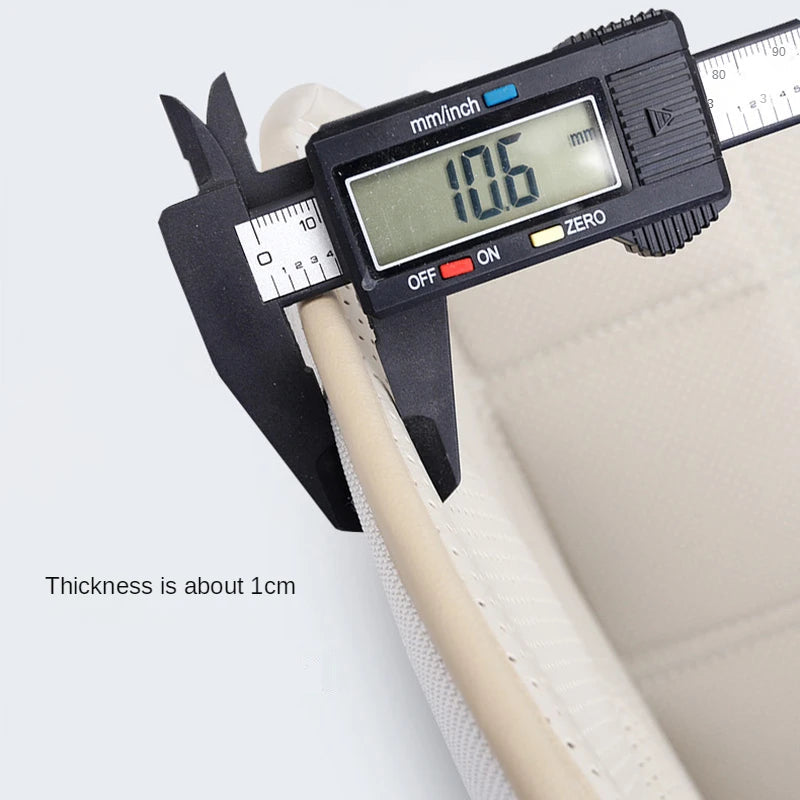 Close-up of a digital caliper measuring the ISOFIX Child Seat Protector padding thickness at approximately 1cm