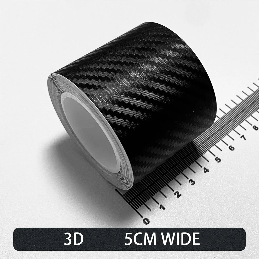 Roll of black Textured 3D carbon fibre wrap tape, 5cm wide, shown on a white background with a ruler for scale.