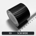 Roll of black Textured 3D carbon fibre wrap tape, 5cm wide, shown on a white background with a ruler for scale.