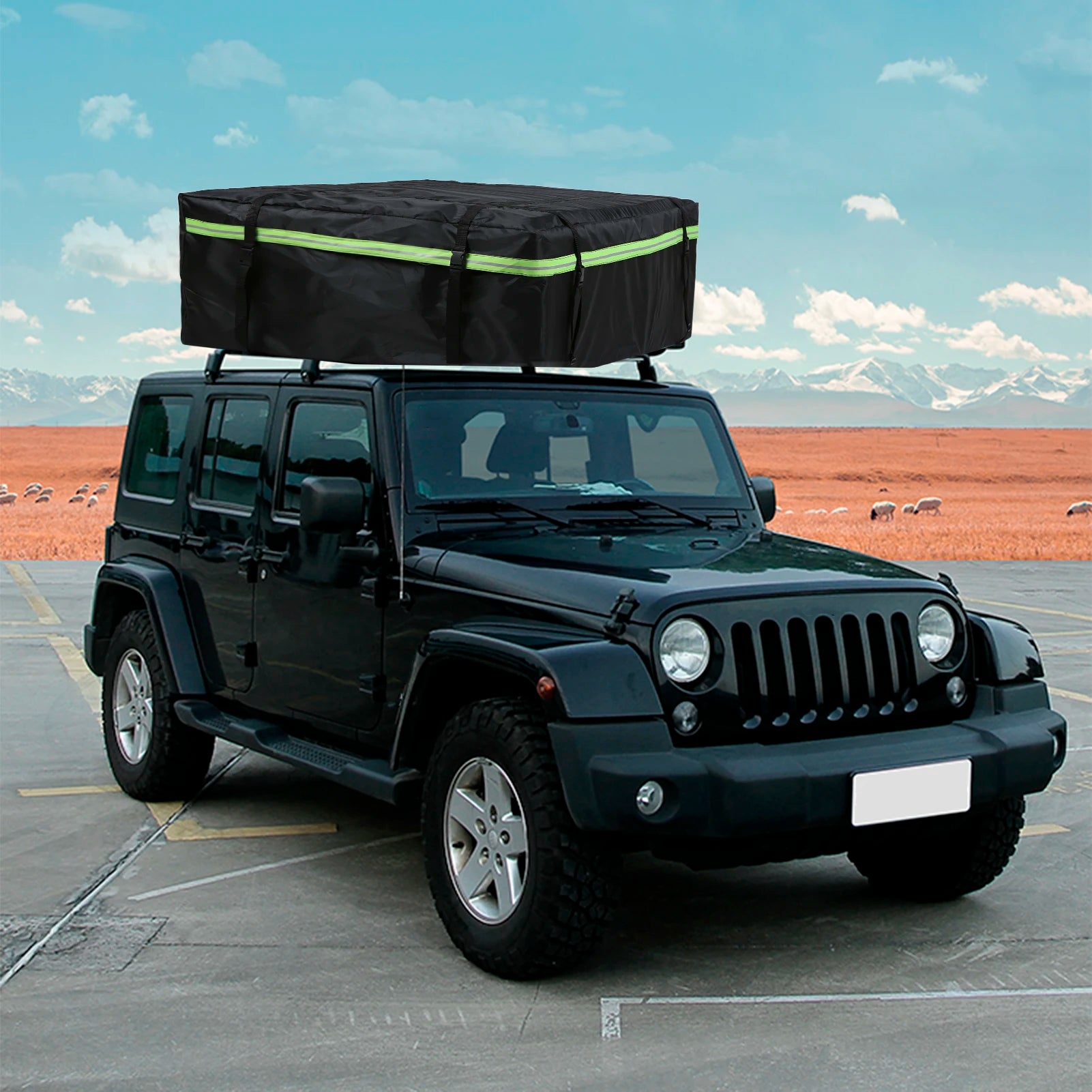 Black waterproof roof cargo bag with reflective stripe strapped to the roof rack of a black Jeep Wrangler parked on red dirt terrain