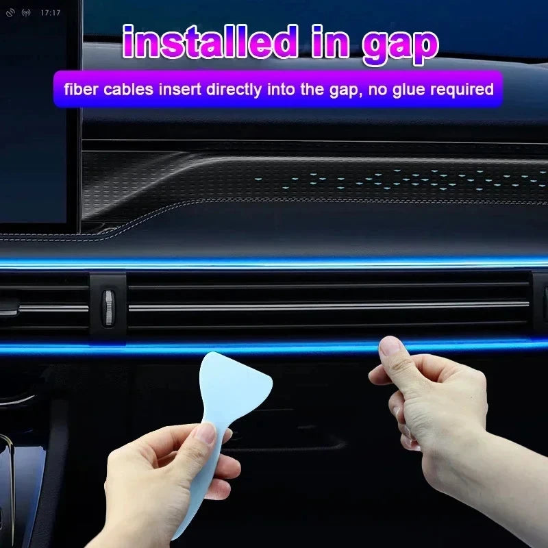 Hand installing the RGB Car Ambient Light Strip fibre optic cable into a dashboard gap, glowing pink