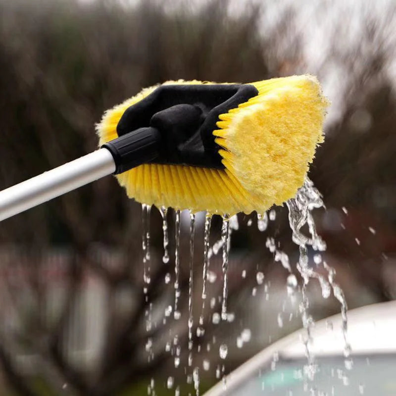 Telescopic Wash Brush being used to scrub and rinse a car roof with soapy water dripping off