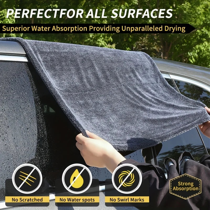 XXL Microfiber Drying Towel draped over a car window being lifted by hand, with no-scratch, no-water-spot and no-swirl-mark badges