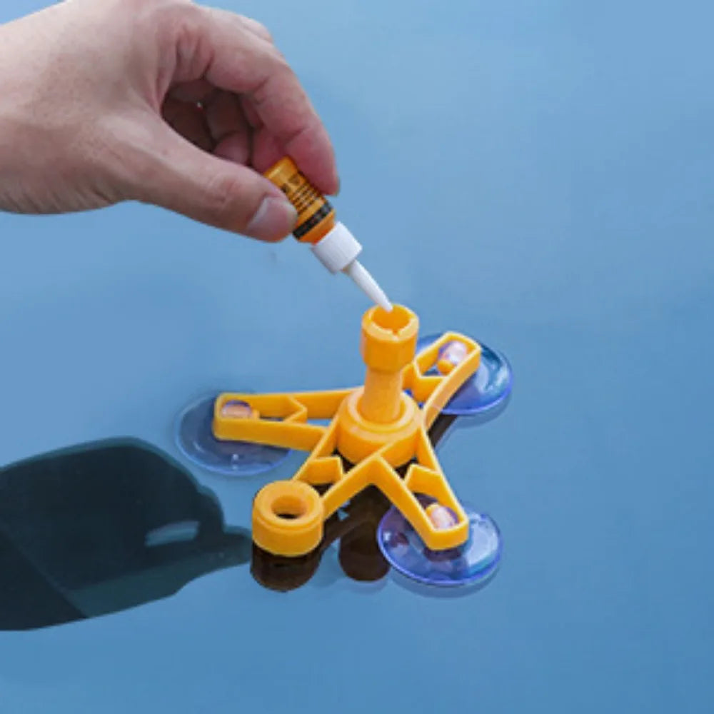 Hand inserting a resin vial into the Windscreen Repair Kit injector tool mounted on a windscreen