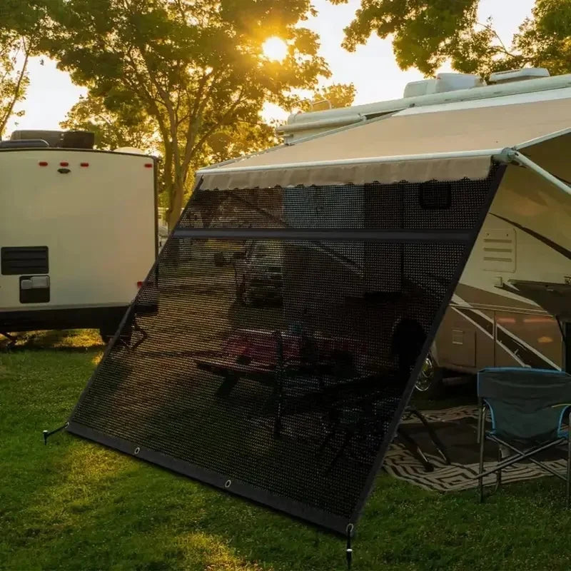 HDPE Sun Shade Net pegged down from a caravan awning on grass, blocking low afternoon sun from the outdoor seating area