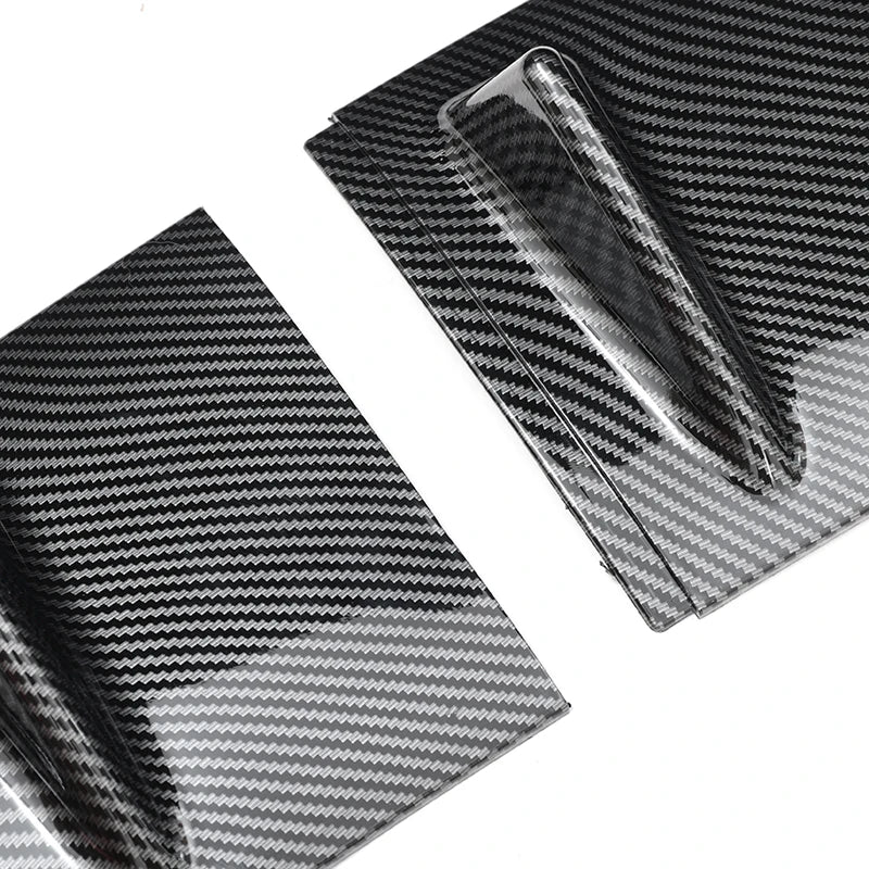 Close up of a carbon fibre textured shark fin rear diffuser panel showing the woven finish