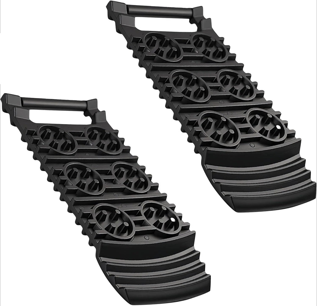 Two black Compact Tyre Traction Mats with grip handles and studded tread on a white background