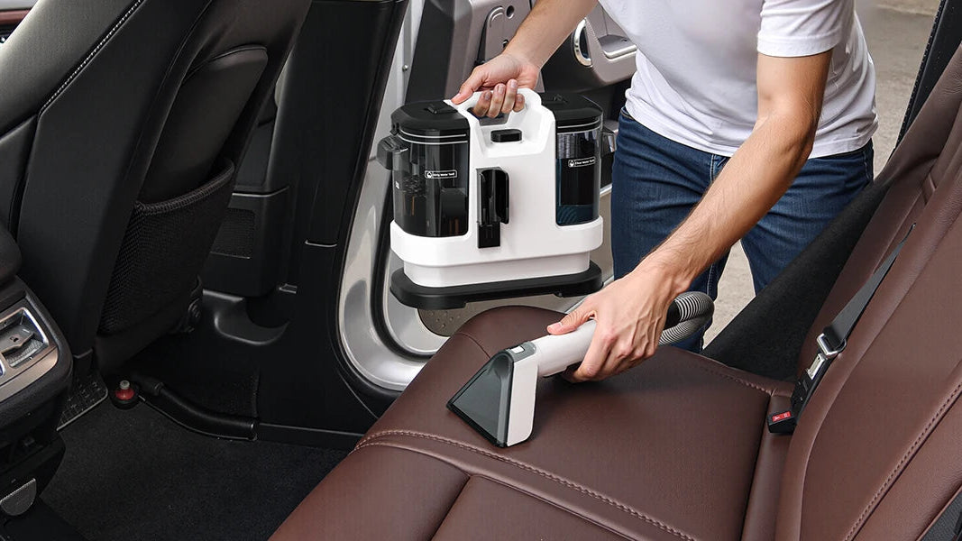 A person uses a handheld car seat cleaning tool on a brown leather car seat inside a vehicle. The image includes a text overlay that reads 'Car Seats'.