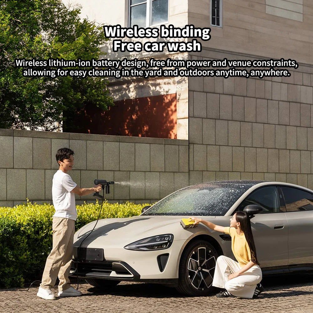 Man using a Cordless Car Pressure Washer to rinse a white car in a driveway while a woman wipes the bonnet