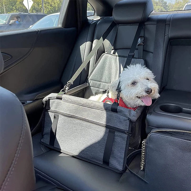White fluffy dog in a grey Hanging Pet Car Seat attached to a black leather car rear seat