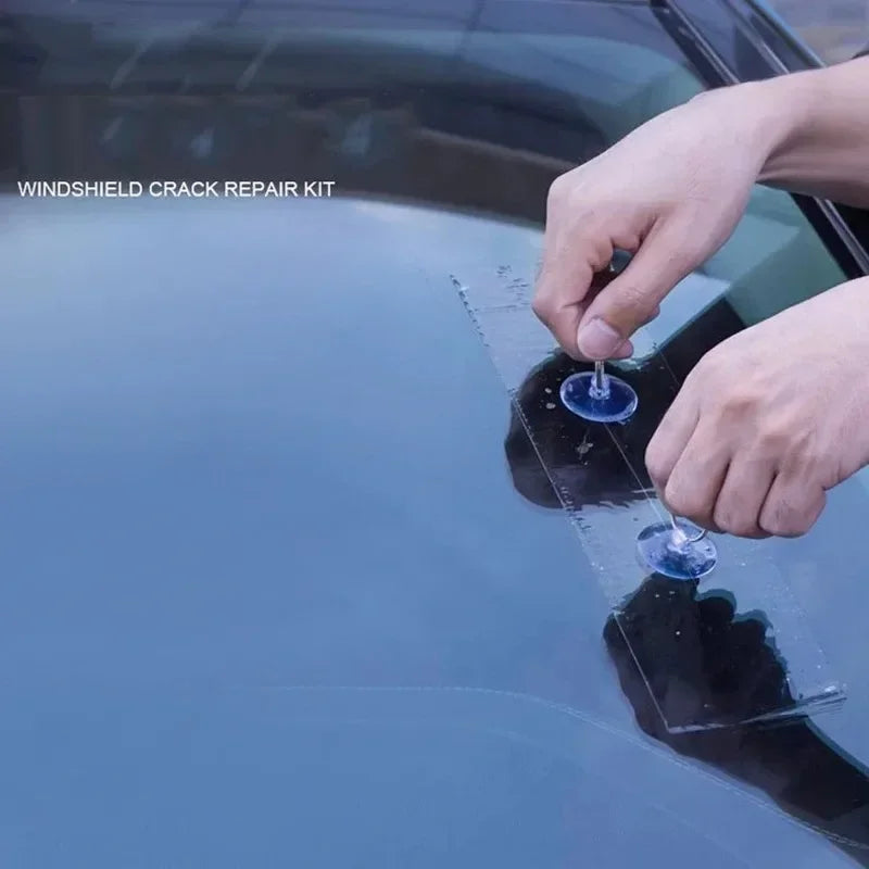 Hand using the Windscreen Repair Kit injector tool to repair a chip on a car windscreen