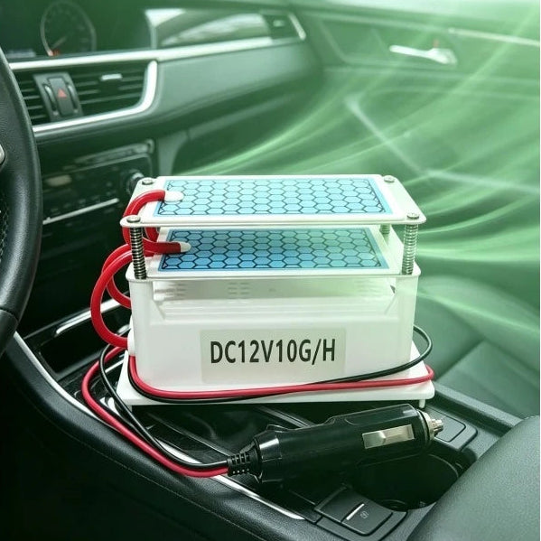 Vehicle Ozone Odour Eliminator placed on a car centre console, plugged into the 12V socket to remove interior odours