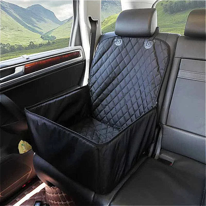 Empty black quilted Waterproof Dog Car Hammock booster seat fitted to a car front seat with a mountain valley view outside