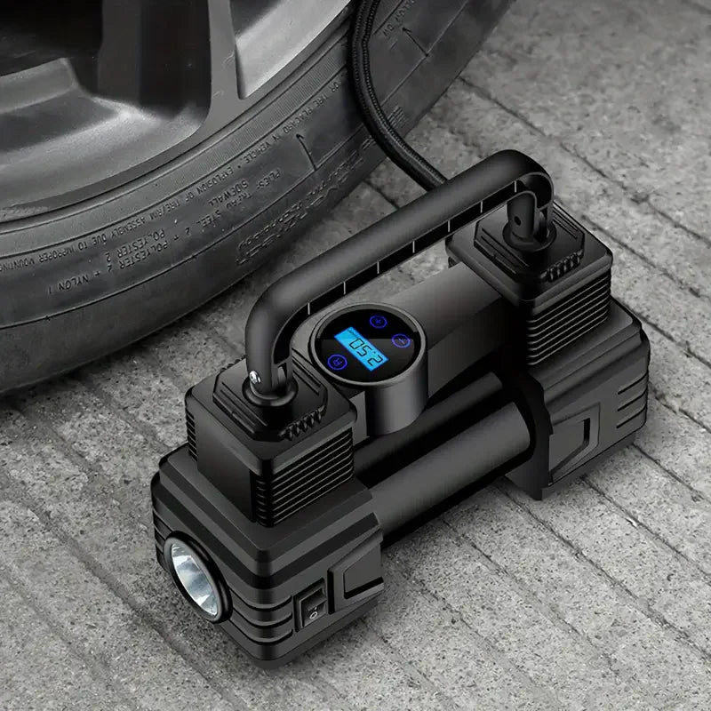 Twin-Cylinder Digital Air Compressor on a concrete floor beside a car tyre with the digital display lit