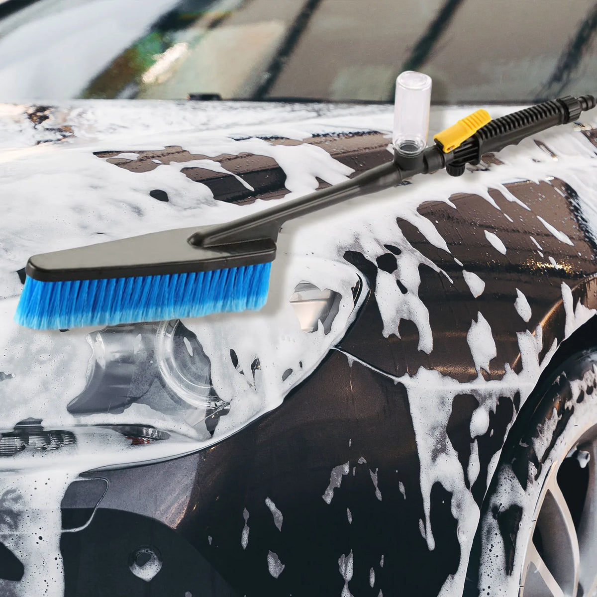 Car Foam Wash Brush scrubbing thick foam suds off a black car bumper