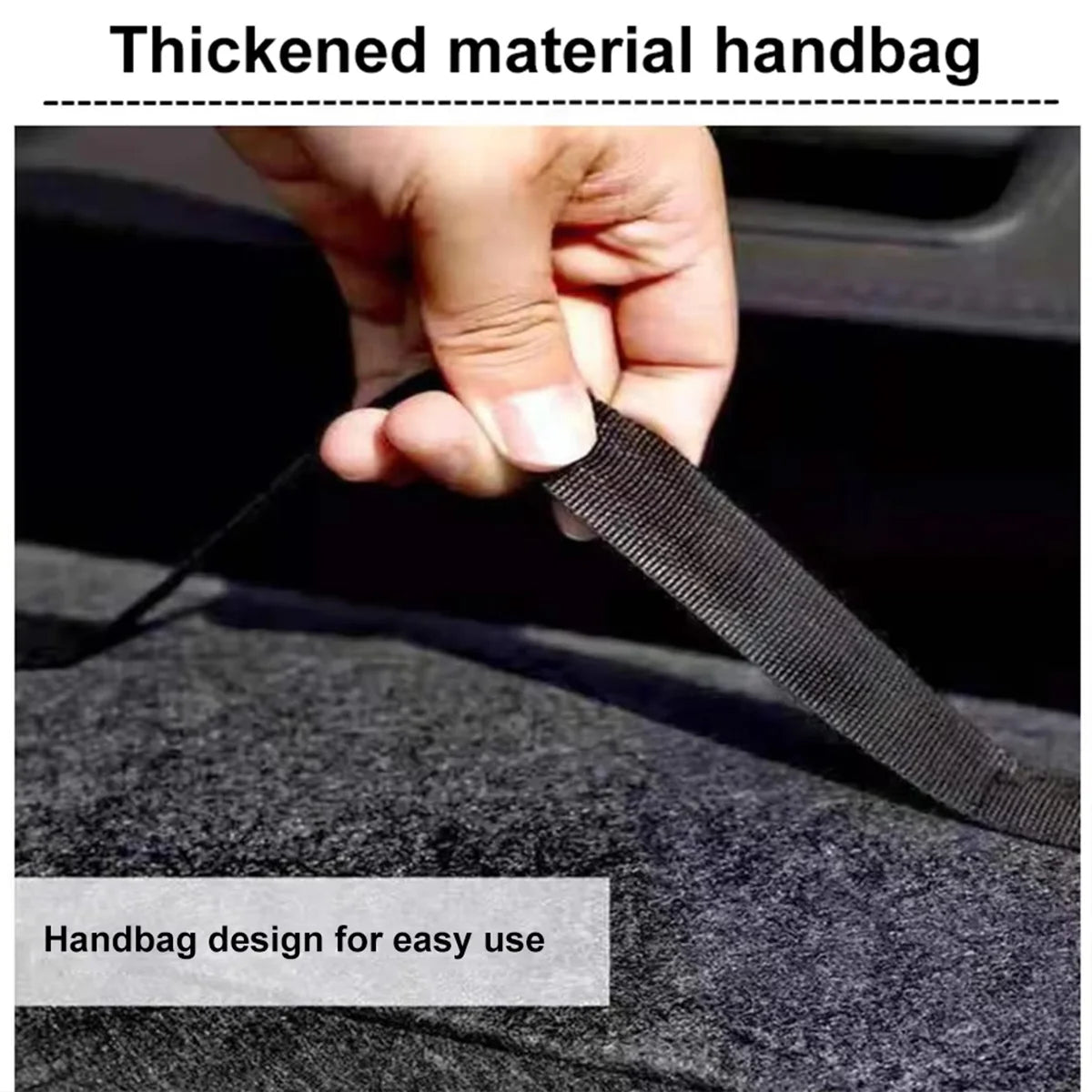 Close-up of a hand pulling the reinforced carry strap of the dark grey felt storage box for easy handbag-style carrying.