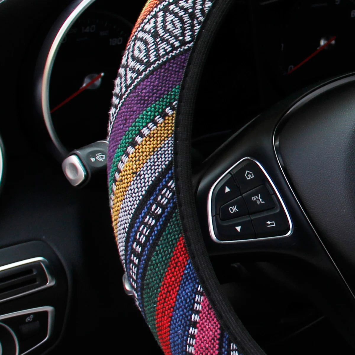 Close-up of the multicolour striped weave on the bohemian linen steering wheel cover fitted to a steering wheel