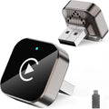Wireless CarPlay adapter shown from two angles with USB-C adapter, featuring a compact metallic design and glowing play button, isolated on a white background.