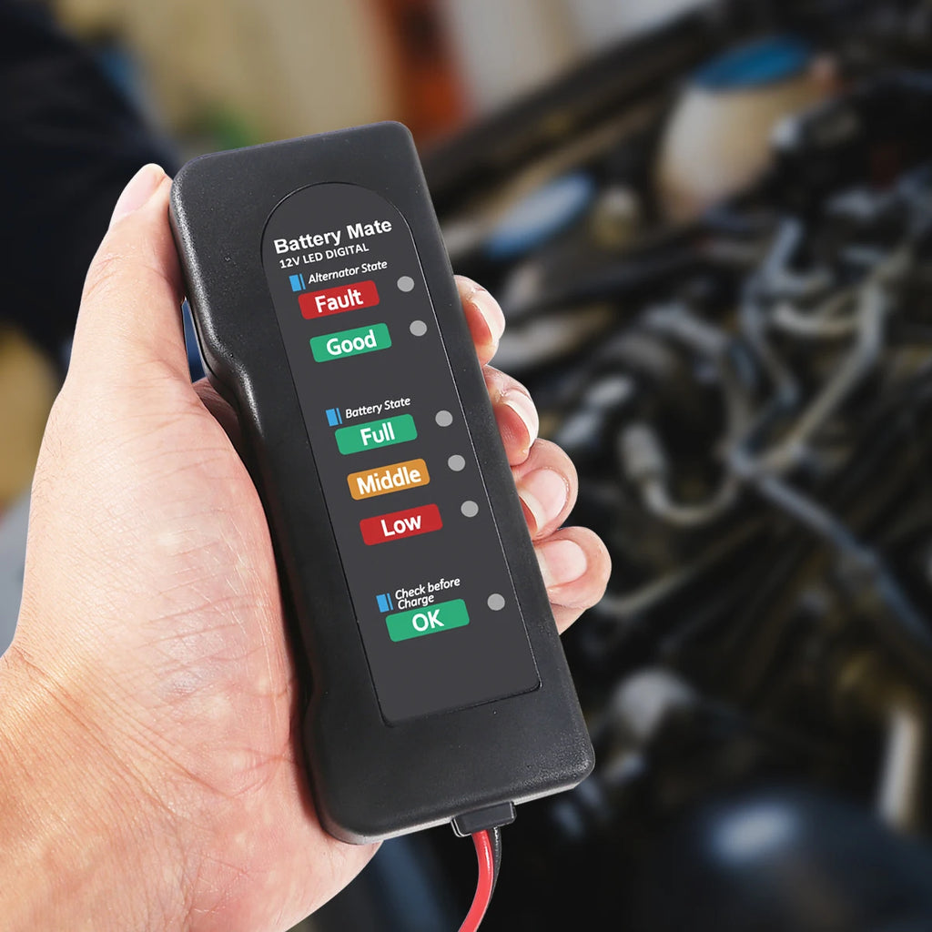 Hand holding the 12V LED Battery and Alternator Tester above a car engine bay, showing alternator and battery status lights