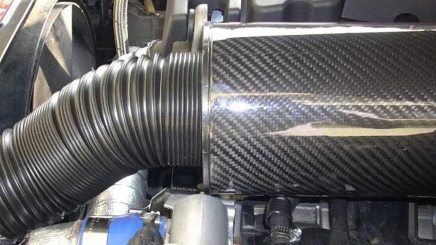 Three-panel close-up collage of a car air intake system with a large black ribbed hose, a shiny black cylindrical component, and a carbon-fiber-textured intake tube mounted in an engine bay.