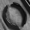 Black Carbon Fibre Wheel Cover unclipped ring on dark background