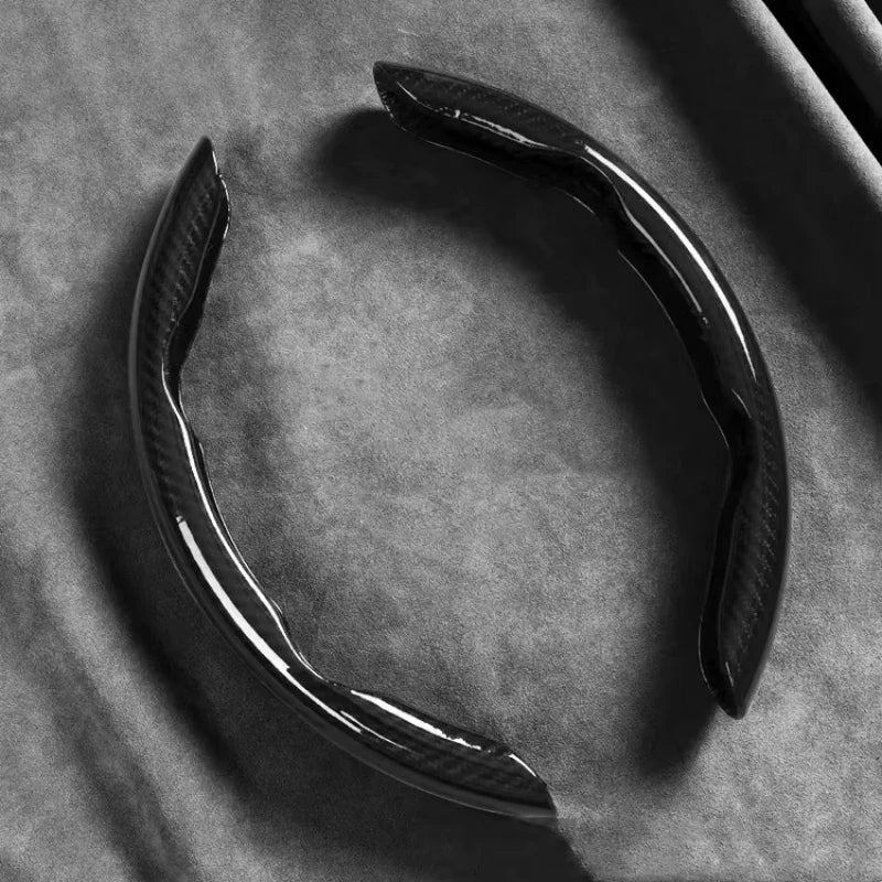 Black Carbon Fibre Wheel Cover unclipped ring on dark background