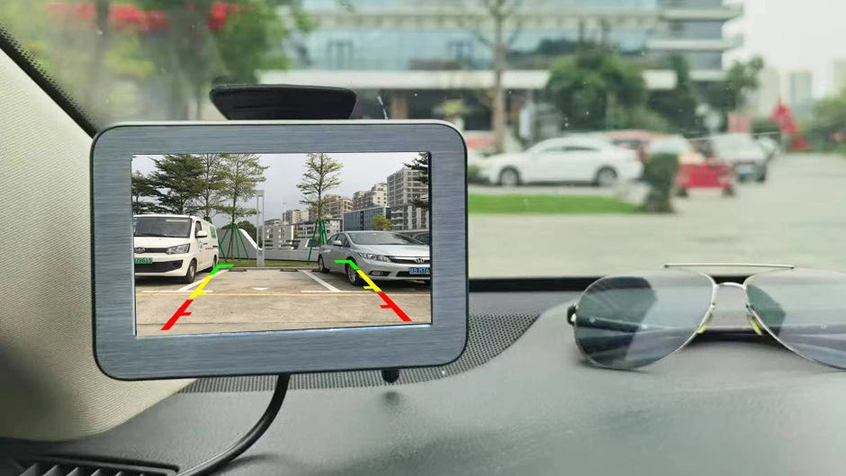 Car dashboard with a rearview camera displaying a parking aid system.
