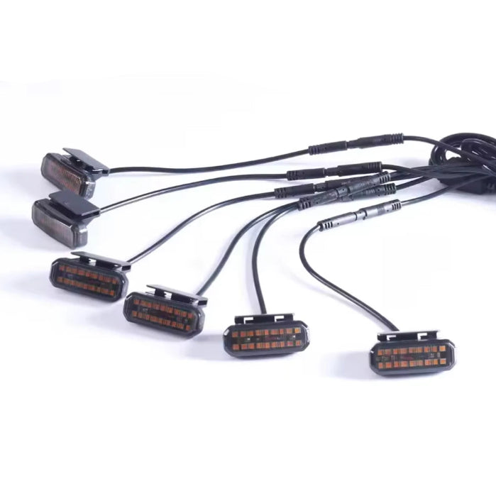 Six Smoked Amber Grille Lights with smoked lenses and connecting wiring harness on a white background