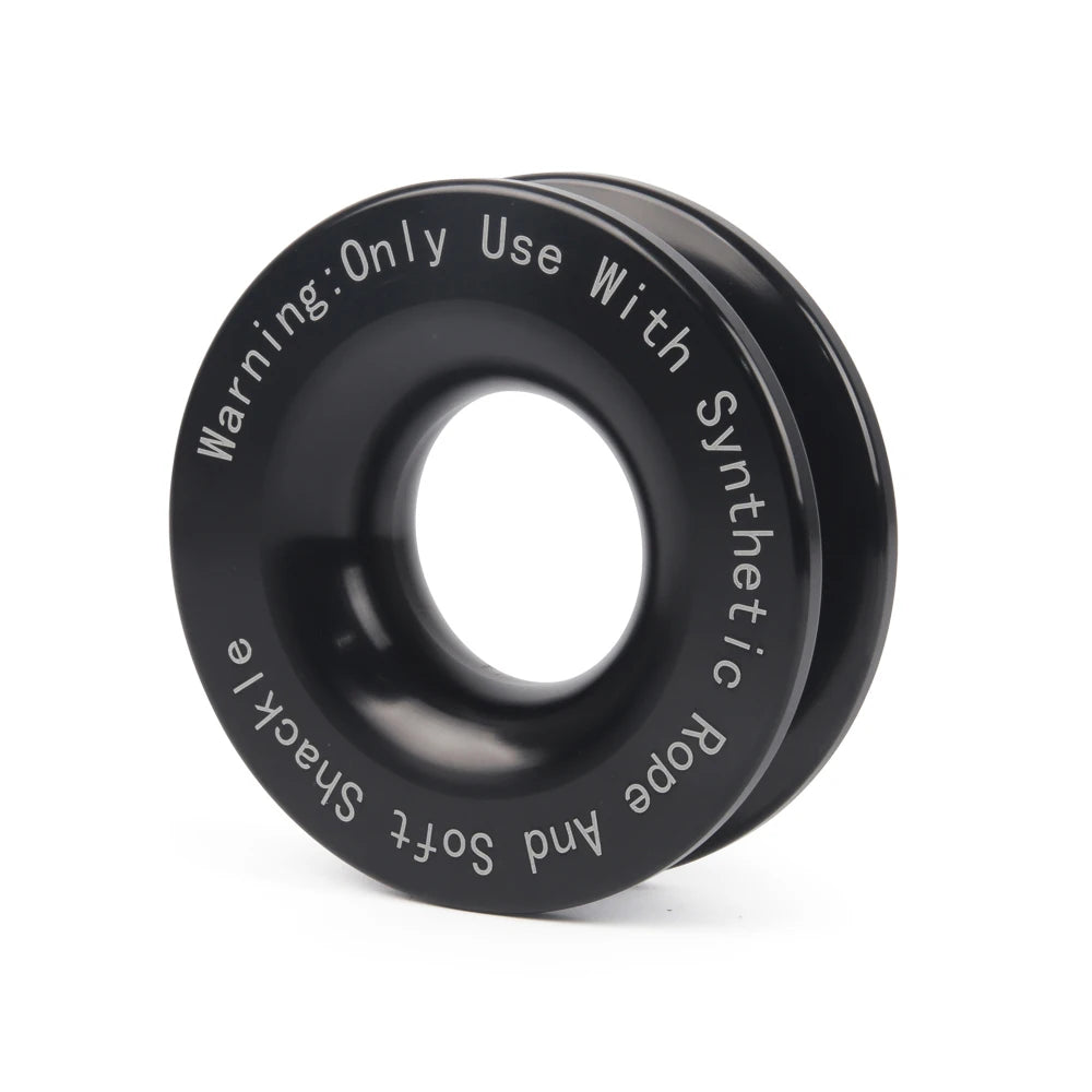Angled view of a black anodised aluminium recovery ring engraved with a synthetic rope safety warning