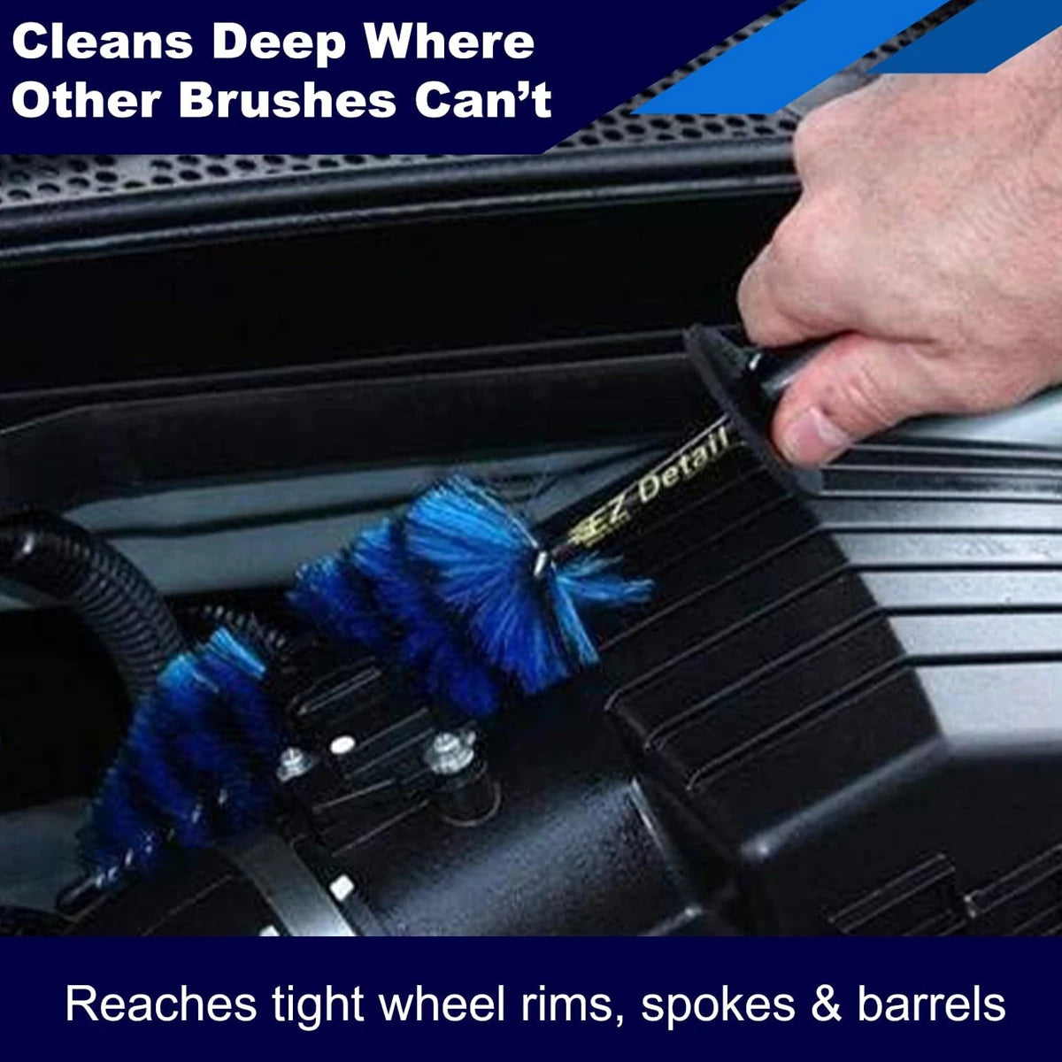 Hand using a blue bristle wheel brush to clean tight alloy wheel spokes and barrels on a car
