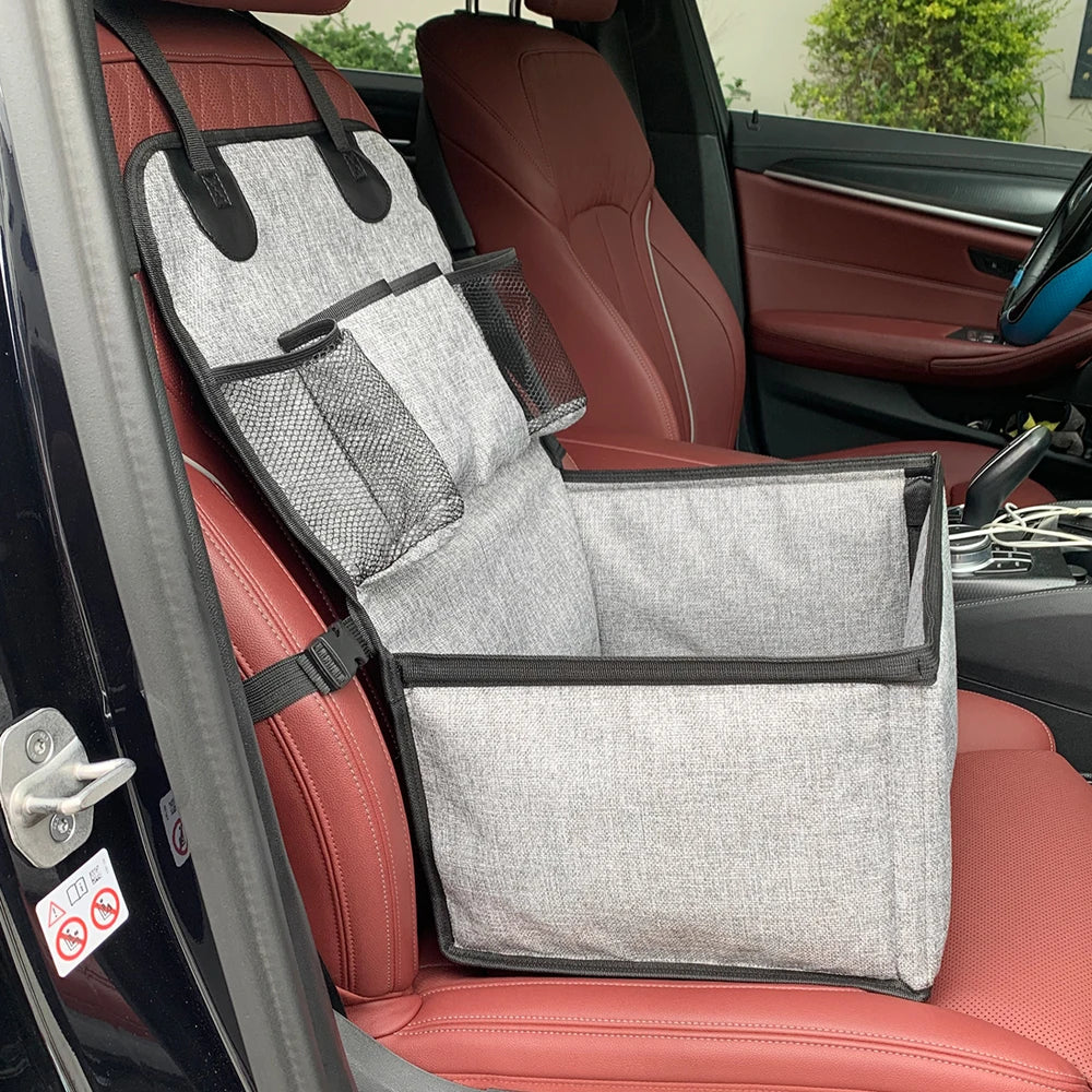 Grey foldable dog car booster seat mounted on a car front passenger seat, ready for pet travel.
