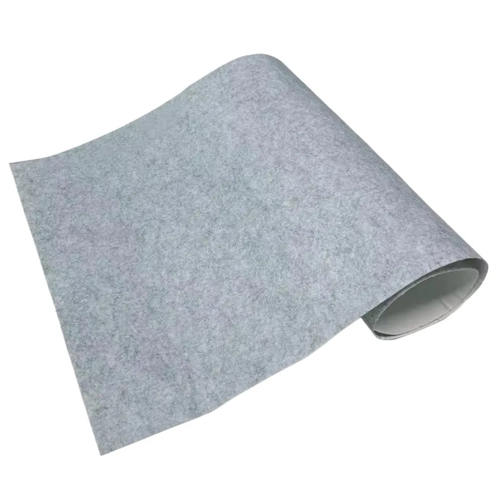 Light grey self-adhesive felt lining sheet rolled at one end on a white background