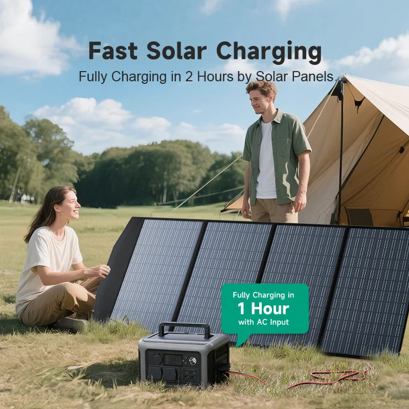 600W LiFePO4 Power Station charging from foldable solar panels on the grass beside a tent, with a couple at a campsite