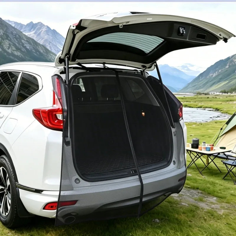 Tailgate Mosquito Net fitted over the open rear hatch of a white SUV, with a campsite and mountains behind