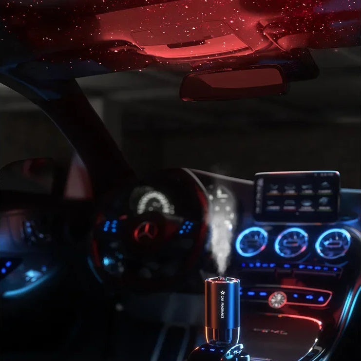 Smart Cup Holder Diffuser releasing fragrance mist in a car centre console at night with ambient interior lighting