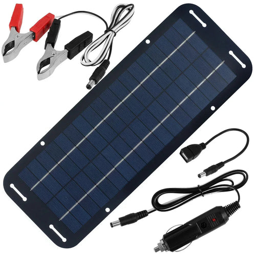 Solar battery trickle charger panel with red and black alligator clips, USB adapter cable and cigarette lighter plug laid flat on a white background