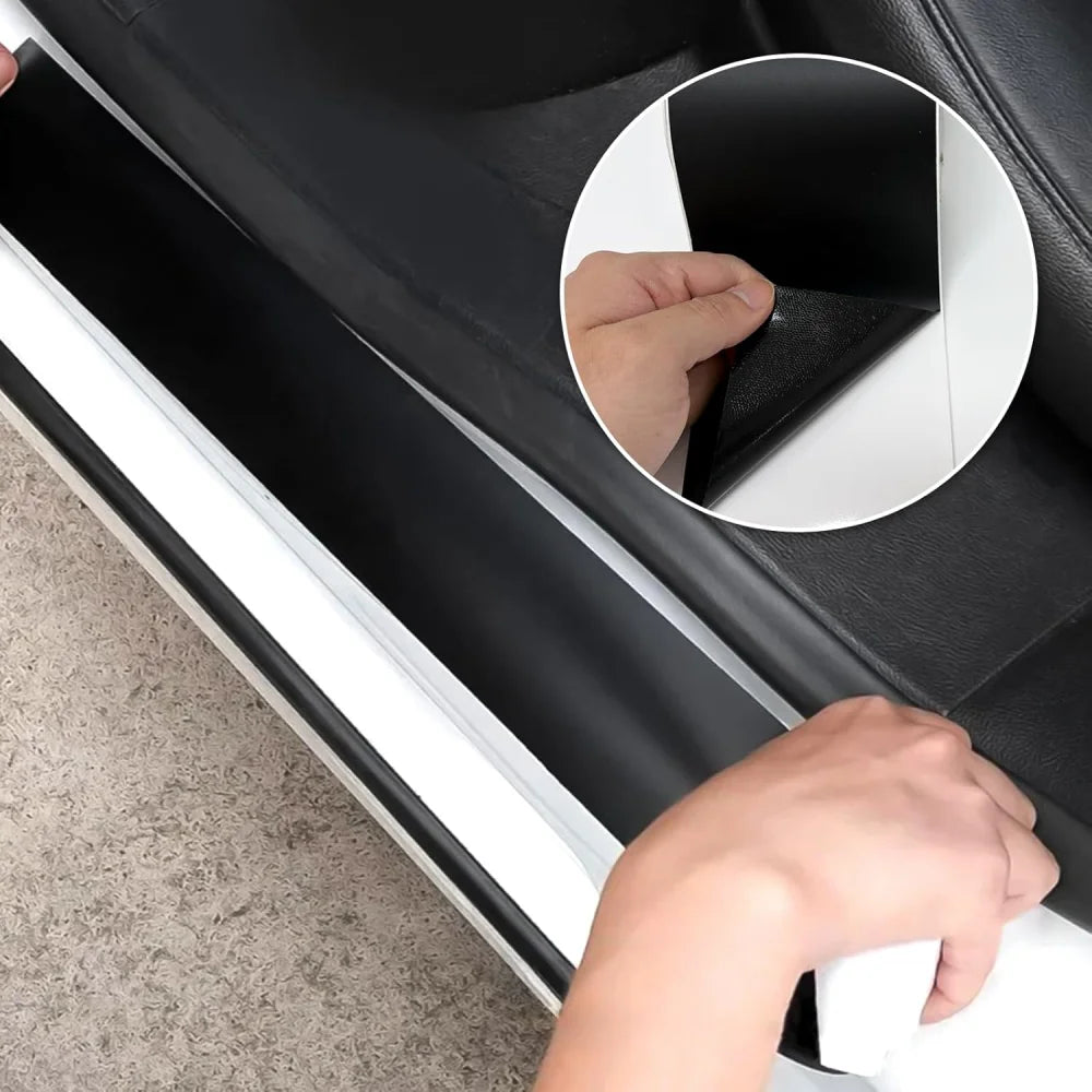 Hand applying Matte Black Trim Wrap to a car's door sill scuff plate with adhesive backing peeled back