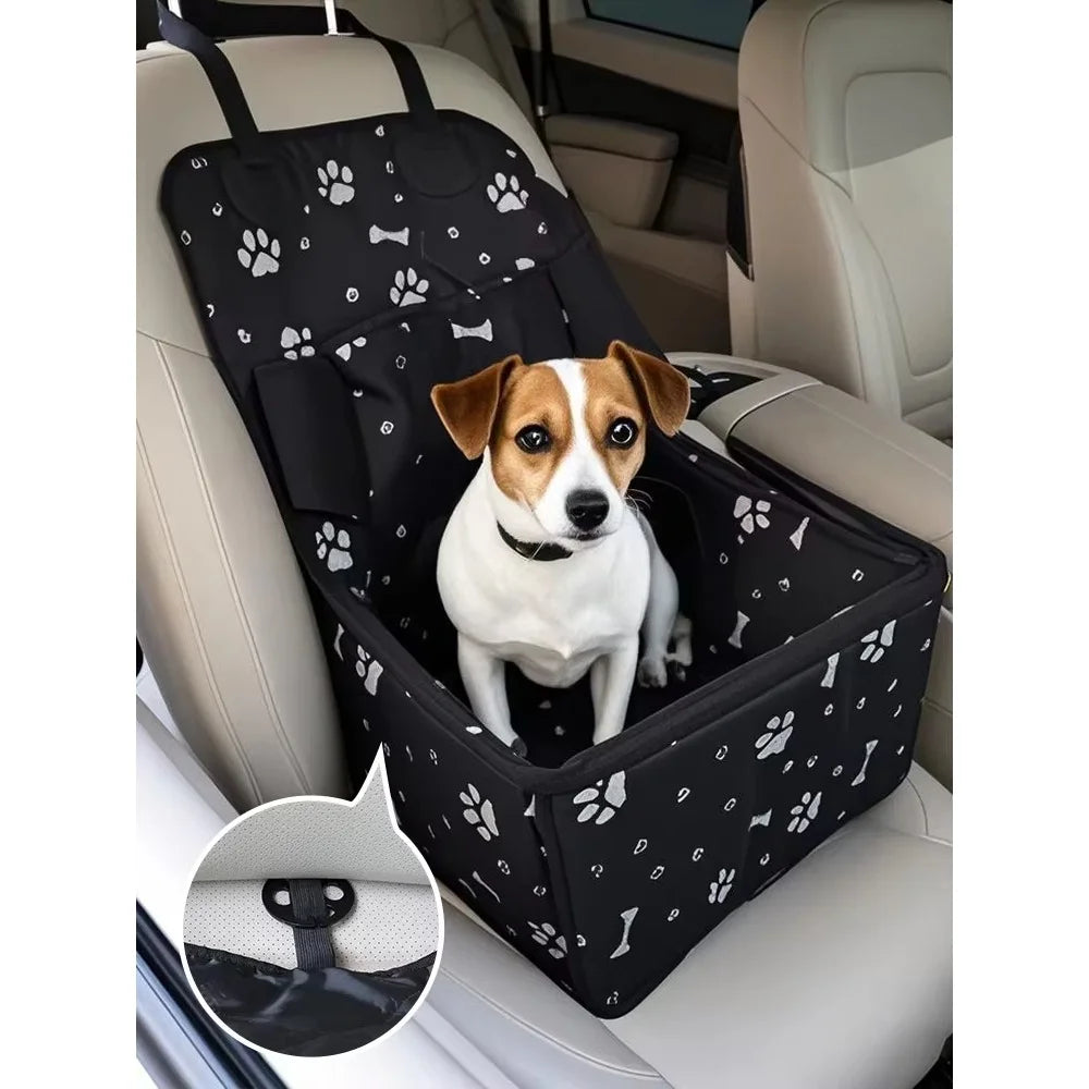 Jack Russell terrier sitting inside a black paw print waterproof dog car booster seat on the rear seat