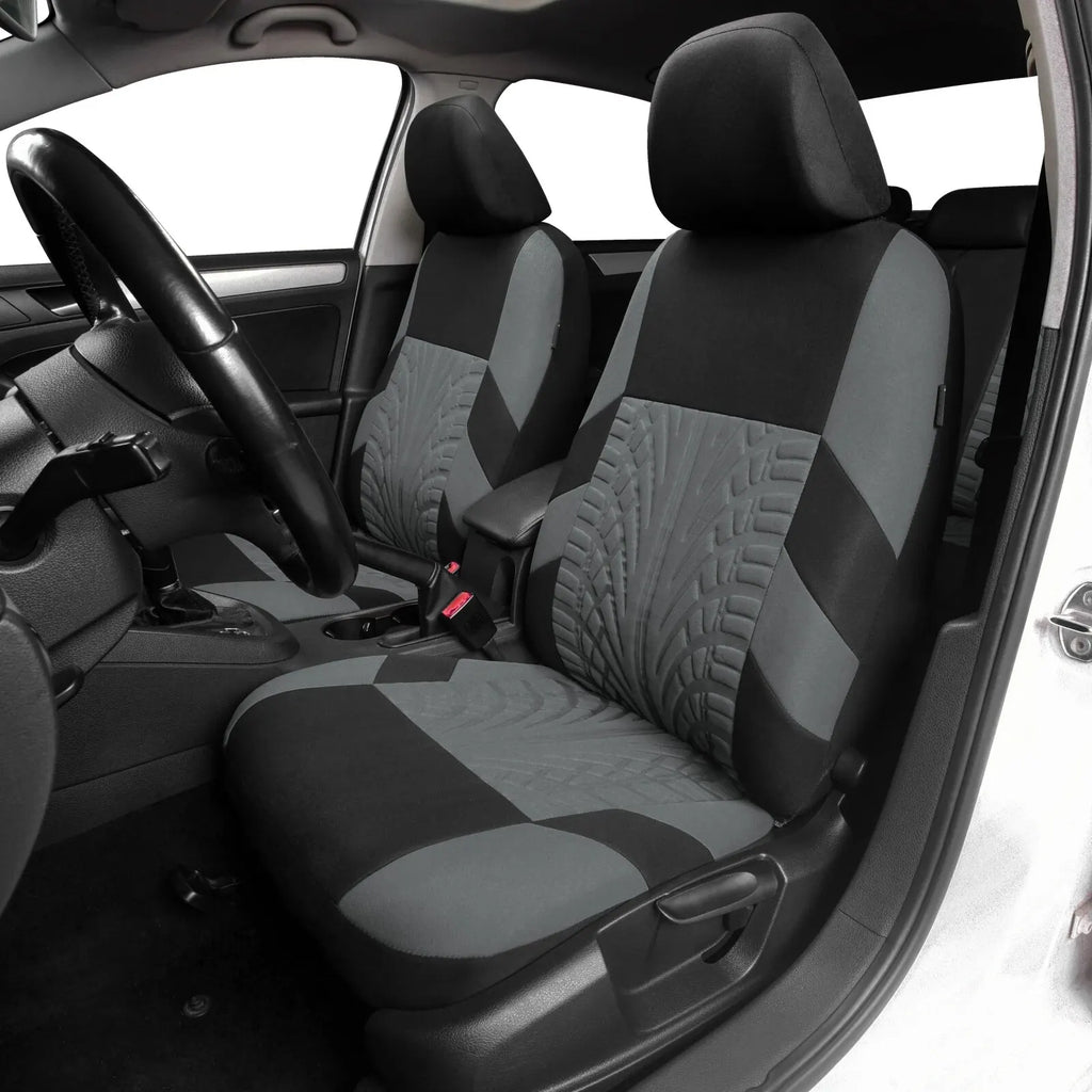 Ash grey and black universal car seat covers installed on the front seats of a real car interior.