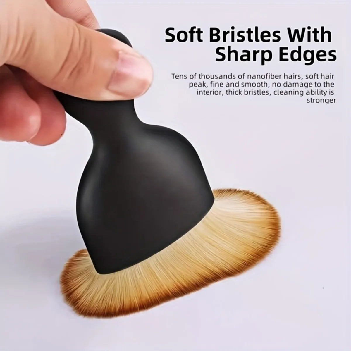 Soft-bristle interior dusting brush from the 20-Piece Car Detailing Kit held in hand