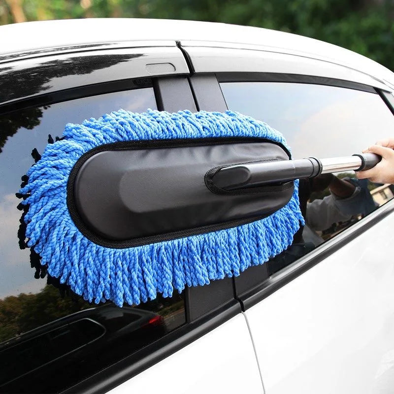 Blue microfibre wash brush mop being used to clean the rear side window of a white car