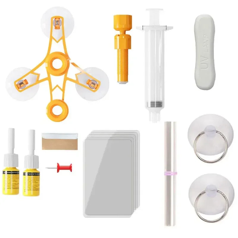 Windscreen Repair Kit components laid out on a white background including injector tool, resin vials, syringe and UV curing strip