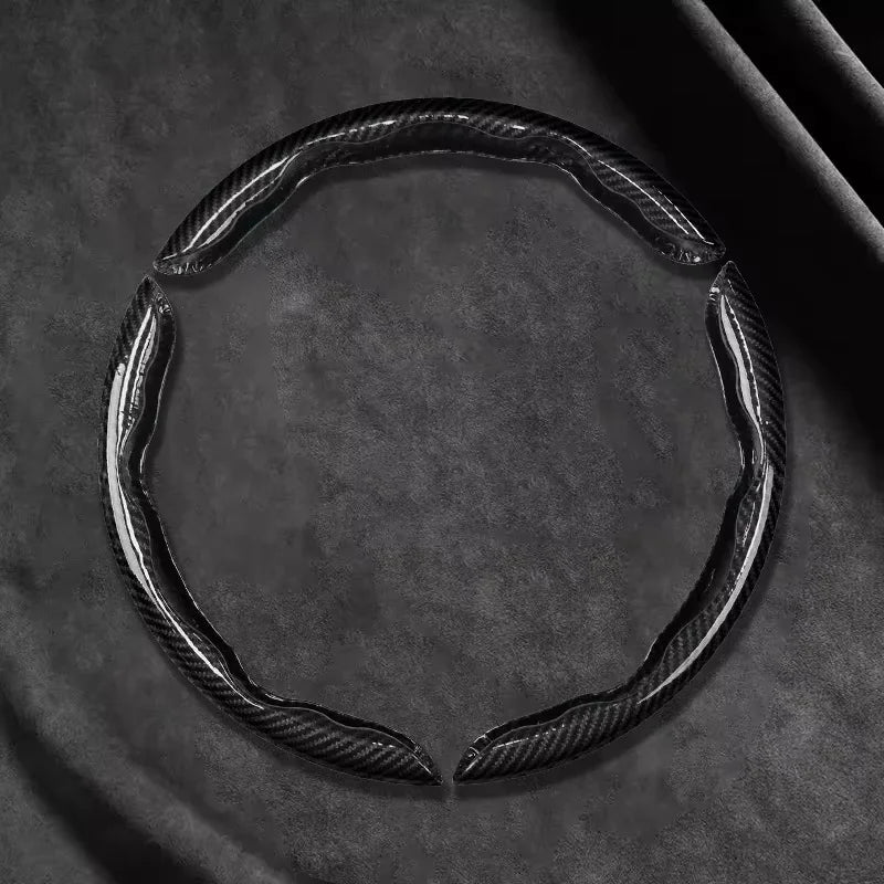 Black Carbon Fibre Wheel Cover open ring detail on dark background