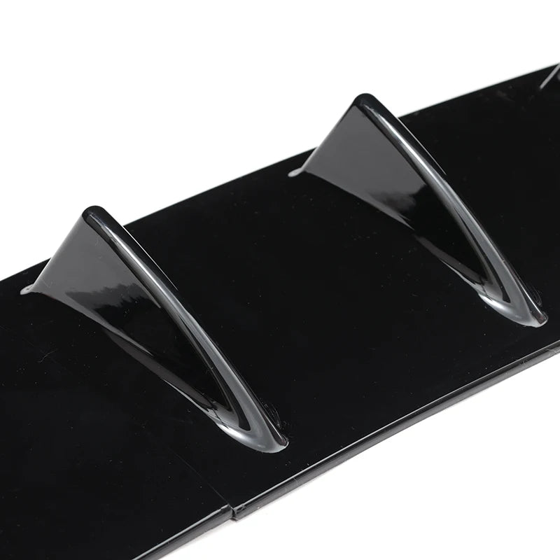 Close up macro shot of two gloss black shark fin diffuser blades highlighting the glossy finish and curved edges