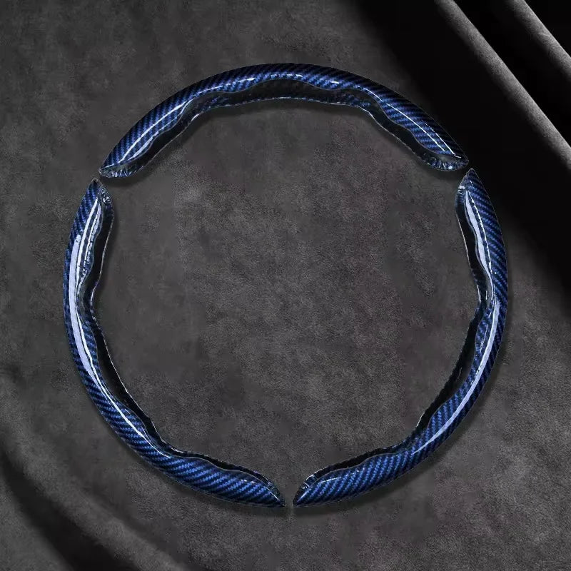 Blue Carbon Fibre Wheel Cover open ring detail on dark background